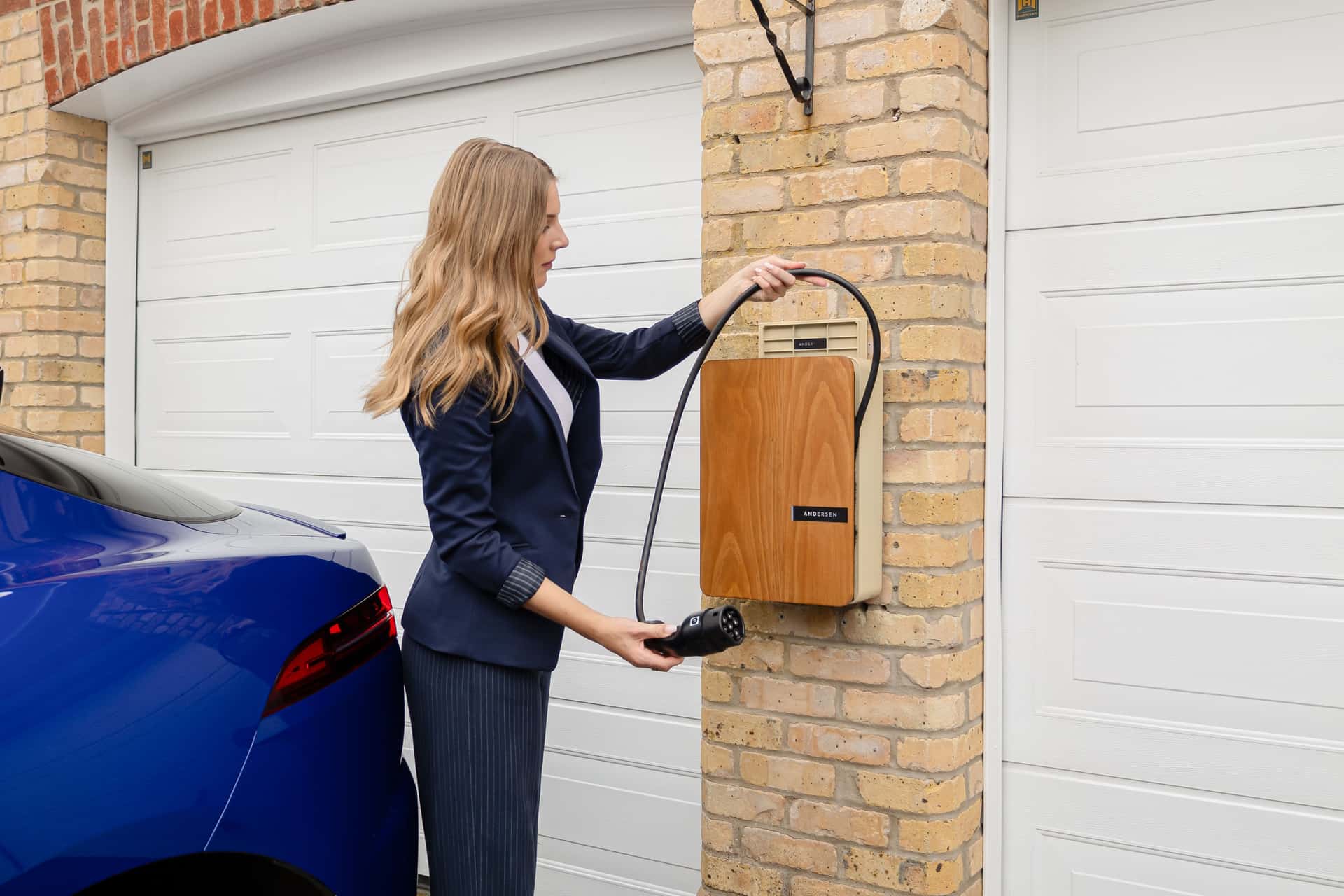 A wall-mounted Level 2 EV charger in a home garage
